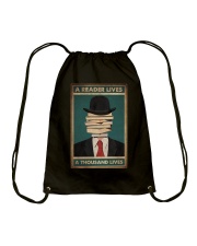 A READER LIVES A THOUSAND LIVES Drawstring Bag tile