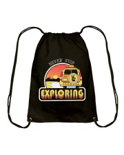 Never Stop Exploring Drawstring Bag tile