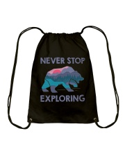 Never Stop Exploring Drawstring Bag tile