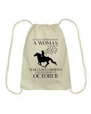 Never Underestimate A Woman Drawstring Bag tile
